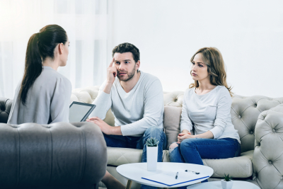 couple visiting a psychologist and having a psychological session while dealing with problems in relationships