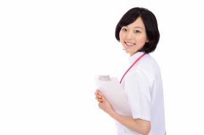 Beautiful asian nurse with a clipboard in white background